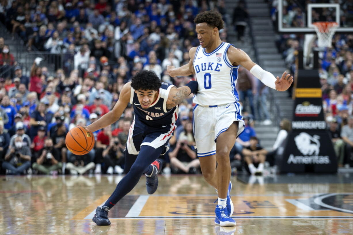 Gonzaga guard Julian Strawther, left, brings the ball up next to Duke forward Wendell Moore Jr. (0) during the first half of an NCAA college basketball game Friday, Nov. 26, 2021, in Las Vegas.