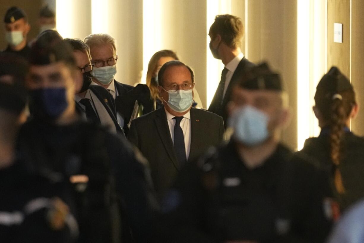 Former French President Francois Hollande, center, arrives at the special courtroom to testify in the Nov.2015 attacks trial, Wednesday, Nov. 10, 2021 in Paris. Hollande was at France's national stadium when a suicide bomber blew himself up outside the gates on Nov. 13, 2015, the first in a series of attacks that would last three more hours across Paris. Gunmen struck cafes and bars in the city center, and the night culminated with a bloody siege at the Bataclan concert hall. In all 130 people died in the attacks. Hollande ordered the final assault on the three remaining attackers inside the Bataclan.