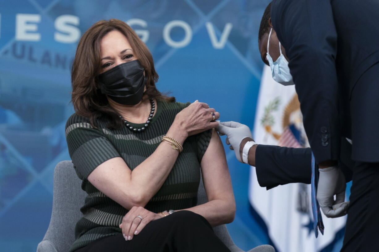 Administering White House medical staff wipes the arm of Vice President Kamala Harris as she is prepared to receive her Moderna COVID-19 vaccine booster shot at the Eisenhower Executive Office Building on the White House complex, in Washington, Saturday, Oct. 30, 2021.