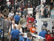 Travelers queue up at the south security checkpoint as traffic increases with the approach of the Thanksgiving Day holiday Tuesday, Nov. 23, 2021, at Denver International Airport in Denver.