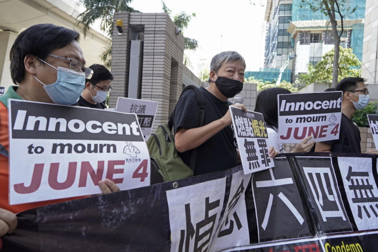 FILE - Pro-democracy activists, including Lee Cheuk-Yan, center, arrive at a court in Hong Kong on Oct. 15, 2020, after being charged of joining an unauthorized assembly on a vigil last June 4 to commemorate the anniversary of the 1989 Tiananmen crackdown. Trials began Monday, Nov. 1, 2021 for Hong Kong tycoon Jimmy Lai and seven other pro-democracy activists charged with inciting others to take part in last year's unauthorized Tiananmen vigil, amid a crackdown on political dissent in Hong Kong.