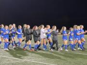 Ridgefield girls soccer players applaud their home fans after defeating Enumclaw 2-0 in the first round of the Class 2A playoffs Wednesday in Ridgefield.