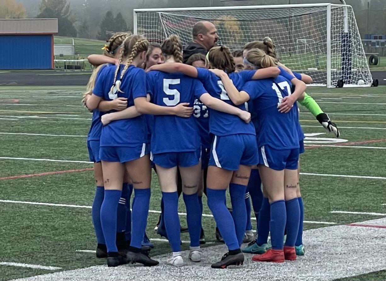 Ridgefield starters huddle prior to the second half of its Class 2A state quarterfinal game against West Valley on Saturday in Ridgefield.