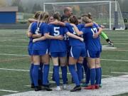 Ridgefield starters huddle prior to the second half of its Class 2A state quarterfinal game against West Valley on Saturday in Ridgefield.