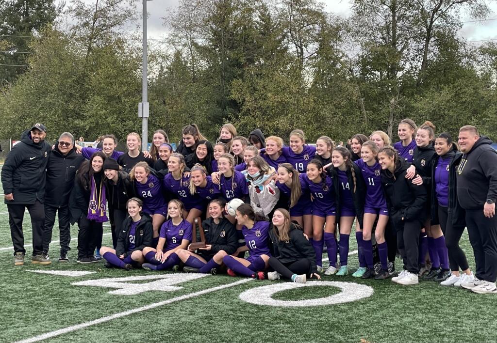 Columbia River poses for a photo with the third-place trophy after defeating Ridgefield on Saturday in Shoreline.