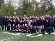 Columbia River poses for a photo with the third-place trophy after defeating Ridgefield on Saturday in Shoreline.