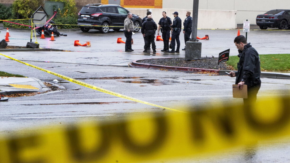 Police collect evidence in a parking lot near the Boise Towne Square shopping mall on Oct. 25 in Boise, Idaho,  where two people were killed in a shooting.