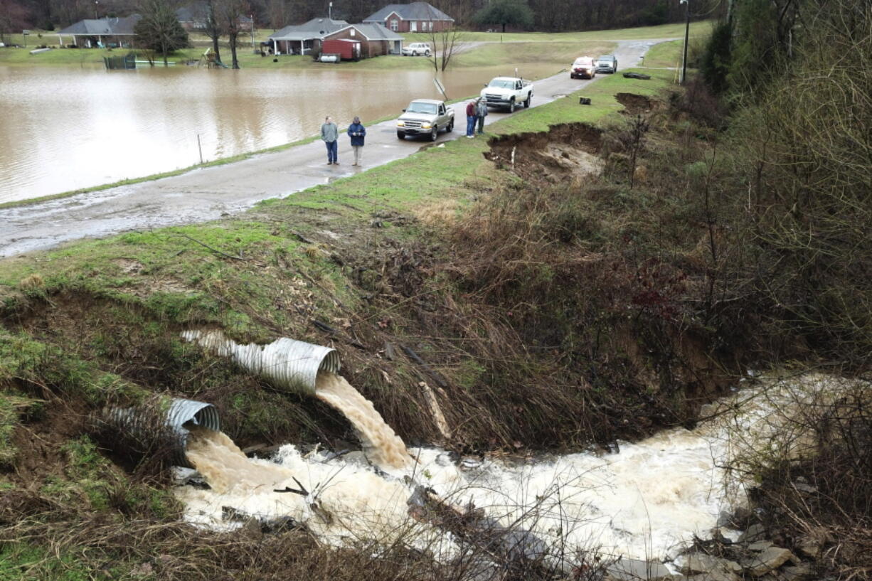 FILE - In this aerial photo provided by the Mississippi Emergency Management Agency, area officials monitor a potential dam/levee failure in the Springridge Place subdivision in Yazoo County, Miss., Tuesday, Feb. 11, 2020. Federal money is poised to flow to states to address a pent-up need to repair, improve or remove thousands of aging dams across the U.S., including some that could devastate downstream towns or neighborhoods. The money is included in a $1 trillion infrastructure bill signed by President Joe Biden and is significantly more than has gone to dams in the past.