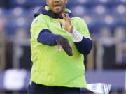 Seattle Seahawks injured quarterback Russell Wilson mimics a throwing motion before an NFL football game against the Jacksonville Jaguars, Sunday, Oct. 31, 2021, in Seattle. (AP Photo/Ted S.