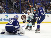 Tampa Bay Lightning goaltender Andrei Vasilevskiy (88) makes a save on a shot by Seattle Kraken right wing Jordan Eberle (7) during the third period of an NHL hockey game Friday, Nov. 26, 2021, in Tampa, Fla. Defending for the Lightning is Mikhail Sergachev (98).