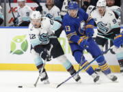 Seattle Kraken center Mason Appleton (22) carries the puck past Buffalo Sabres defenseman Mark Pysyk (13) during the second period of an NHL hockey game, Monday, Nov. 29, 2021, in Buffalo, N.Y. (AP Photo/Jeffrey T.