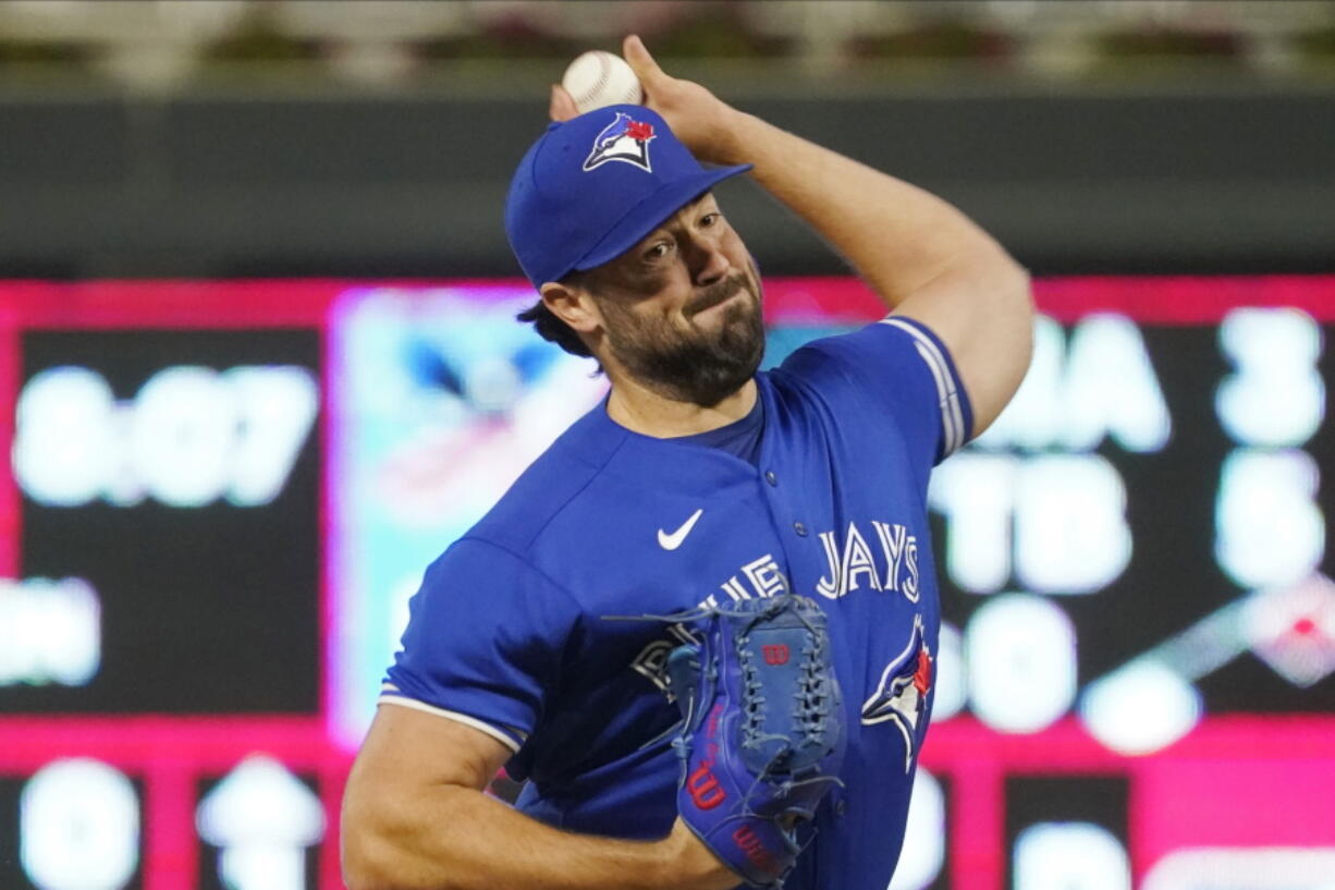 FILE -Toronto Blue Jays pitcher Robbie Ray throws against the Minnesota Twins in the first inning of a baseball game, Saturday, Sept. 25, 2021, in Minneapolis. The Seattle Mariners are finalizing a contract with American League Cy Young Award winner Robbie Ray, according to a person with knowledge of the deal. The person spoke to The Associated Press on Monday, Nov. 29, 2021 on the condition of anonymity because Ray still must undergo a physical and the deal has not been signed.