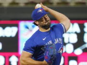 FILE -Toronto Blue Jays pitcher Robbie Ray throws against the Minnesota Twins in the first inning of a baseball game, Saturday, Sept. 25, 2021, in Minneapolis. The Seattle Mariners are finalizing a contract with American League Cy Young Award winner Robbie Ray, according to a person with knowledge of the deal. The person spoke to The Associated Press on Monday, Nov. 29, 2021 on the condition of anonymity because Ray still must undergo a physical and the deal has not been signed.