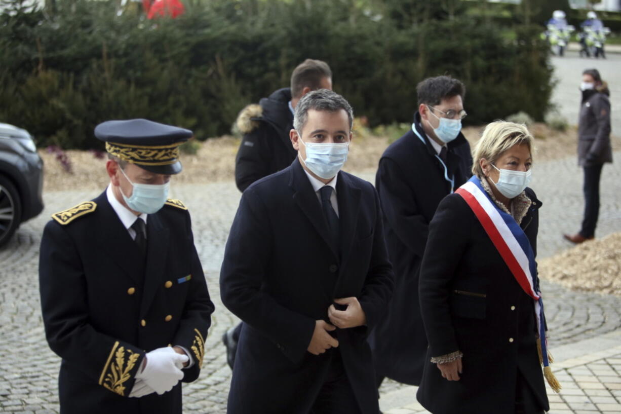 Interior Minister Gerald Darmanin, center, arrives for a meeting with European migration officials, in Calais, northern France, Sunday, Nov. 28, 2021. Top European migration officials are holding an emergency meeting Sunday in the French port of Calais to find ways to better fight migrant smuggling, after 27 people died trying to cross the English Channel to Britain in an overcrowded inflatable boat.