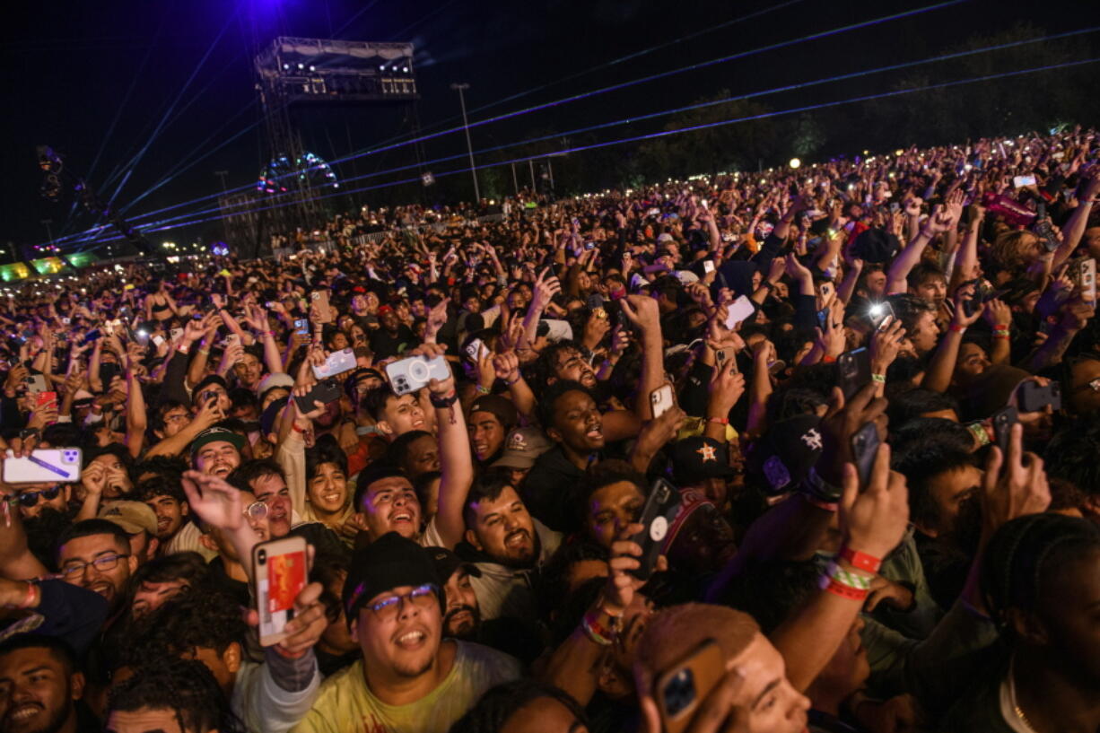 The crowd watches as Travis Scott performs at Astroworld Festival at NRG park on Friday, Nov.  5, 2021 in Houston. Several people died and numerous others were injured in what officials described as a surge of the crowd at the music festival while Scott was performing. Officials declared a "mass casualty incident" just after 9 p.m. Friday during the festival where an estimated 50,000 people were in attendance, Houston Fire Chief Samuel Pe?a told reporters at a news conference.