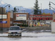 Floodwater covers a roadway near a closed crossing to Canada, Wednesday, Nov. 17, 2021, in Sumas, Wash. An atmospheric river'??a huge plume of moisture extending over the Pacific and into Washington and Oregon'??caused heavy rainfall in recent days, bringing major flooding in the area.