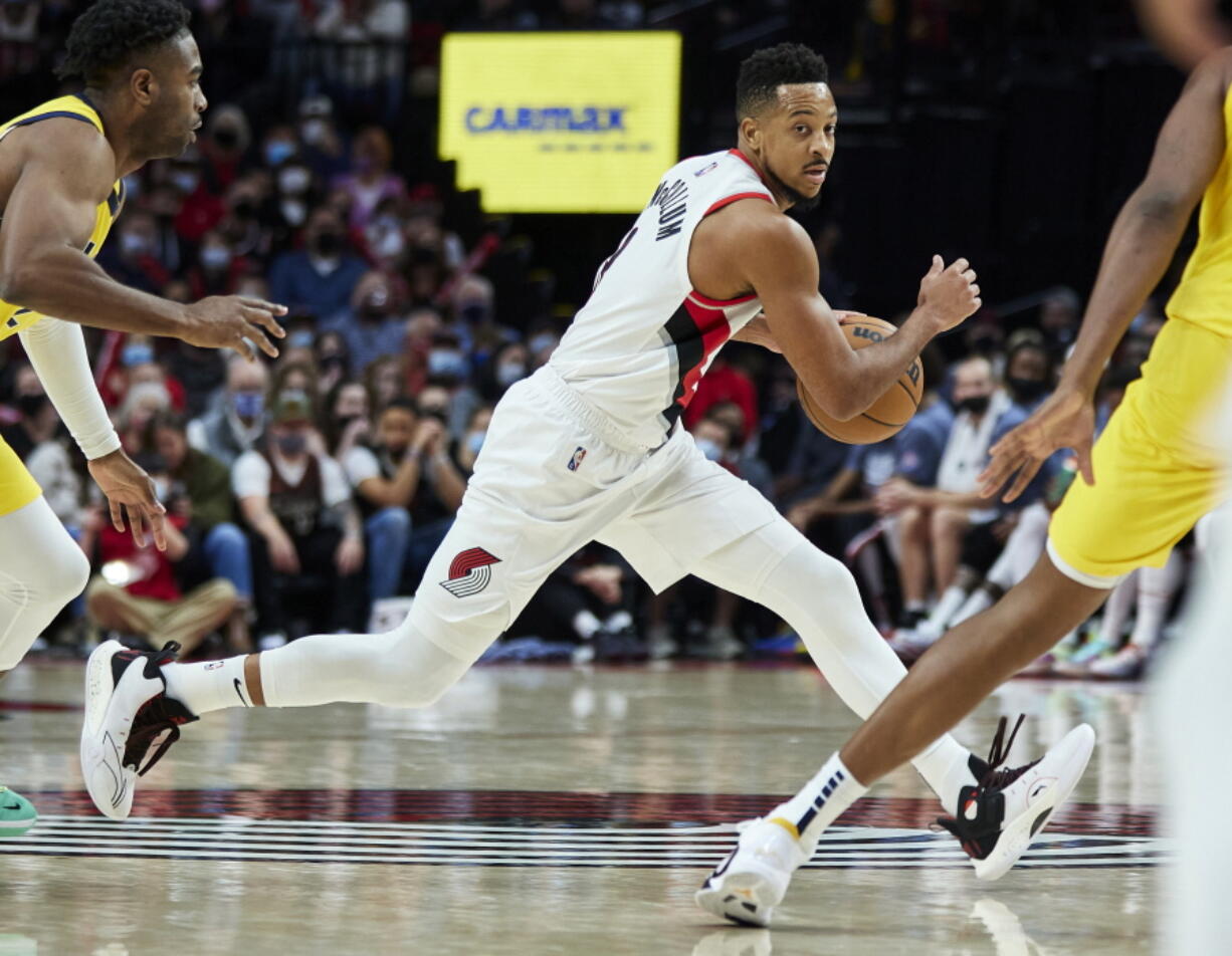 Portland Trail Blazers guard CJ McCollum dribbles during the second half of the team's NBA basketball game against the Indiana Pacers in Portland, Ore., Friday, Nov. 5, 2021.