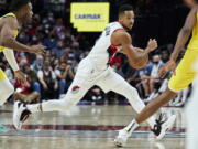 Portland Trail Blazers guard CJ McCollum dribbles during the second half of the team's NBA basketball game against the Indiana Pacers in Portland, Ore., Friday, Nov. 5, 2021.