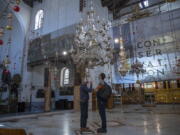 Tourists visit the Church of the Nativity, in the West Bank city of Bethlehem, Tuesday, Nov. 16, 2021. The Church of the Nativity, built on the spot where Christians believe Jesus was born, is wrapping up a three-year restoration project just in time for the normally busy Christmas season.