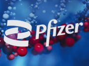 FILE - The Pfizer logo is displayed at the company's headquarters in New York, on Feb. 5, 2021. In a statement on Tuesday, Nov. 16, 2021, drugmaker Pfizer Inc. said it has signed a deal with a U.N.-backed group to allow other manufacturers to make its experimental coronavirus pill, in a move that could make its treatment available to more than half of the world's population.