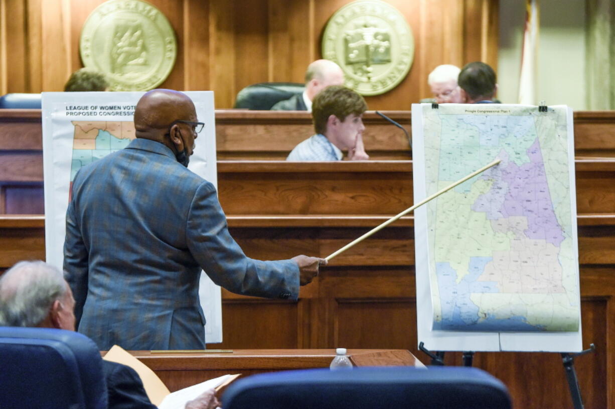 FILE - Sen. Rodger Smitherman compares U.S. Representative district maps during the special session on redistricting at the Alabama Statehouse in Montgomery, Ala., Nov. 3, 2021.