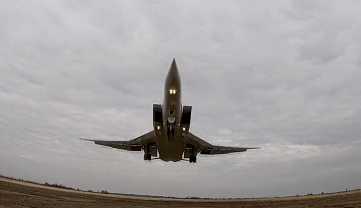 In this handout photo taken from video released by Russian Defense Ministry Press Service on Wednesday, Nov. 10, 2021, a long-range Tu-22M3 bomber of the Russian Aerospace Forces takes-off to patrol in the airspace of Belarus, Thursday, Nov. 11, 2021. Russia has sent two nuclear-capable strategic bombers on a training mission over Belarus in a show of Moscow's support for its ally amid a dispute over migration at the Polish border. Russia has supported Belarus amid a tense standoff this week as thousands of migrants gathered on the Belarus-Poland border in hopes of crossing into Europe.