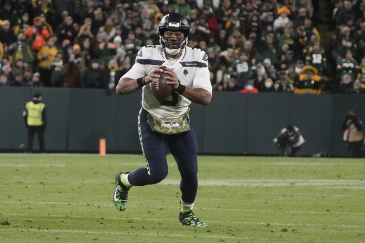 Seattle Seahawks' Russell Wilson scrambles during the second half of an NFL football game against the Green Bay Packers Sunday, Nov. 14, 2021, in Green Bay, Wis.