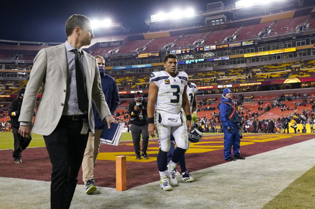 Seattle Seahawks quarterback Russell Wilson walks off the field at the end of an NFL football game against the Washington Football Team, Monday, Nov. 29, 2021, in Landover, Md. Washington won 17-15.