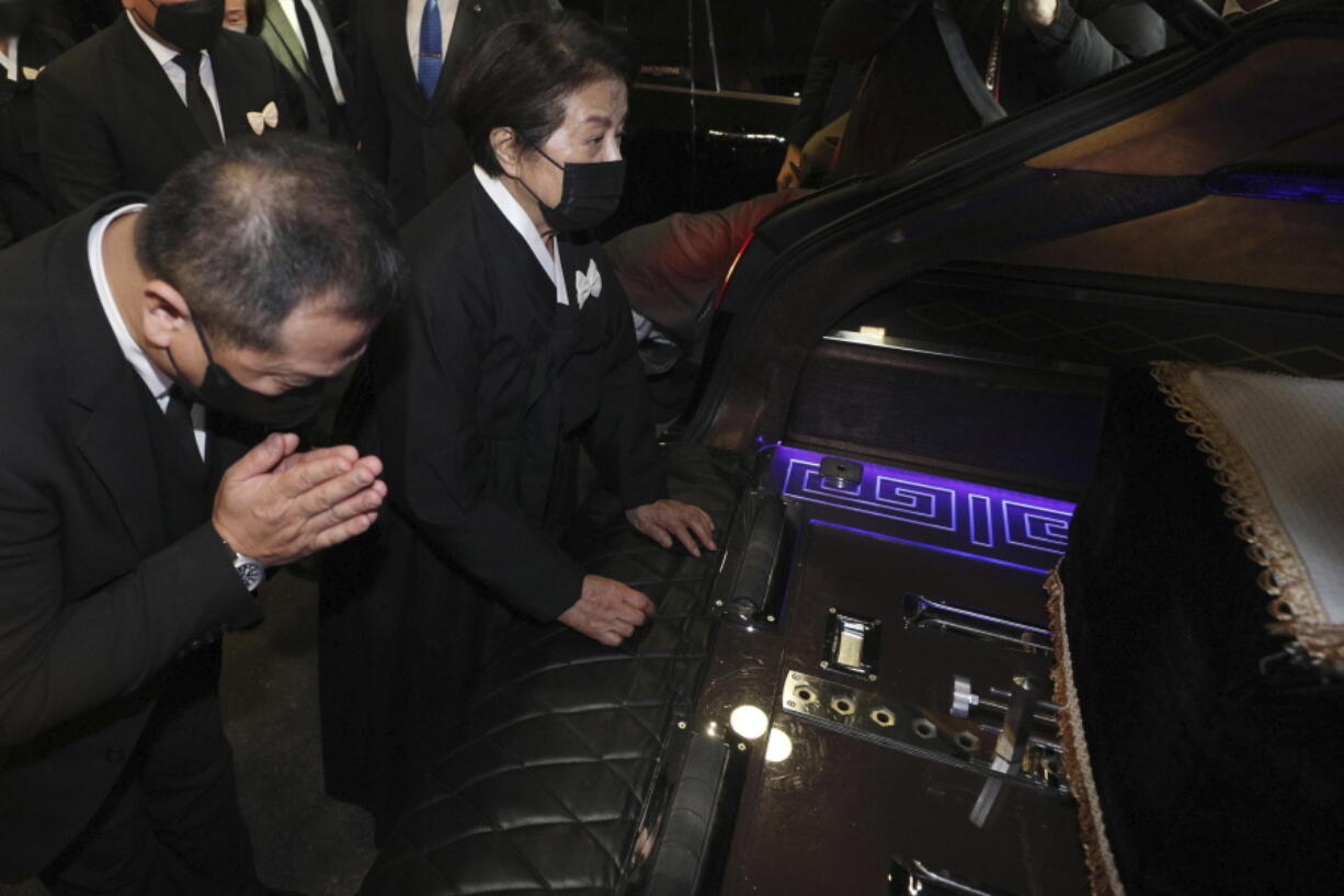 Lee Soon-ja, second from right, the wife of the late former South Korean President Chun Doo-hwan, watches the coffin containing the body of her husband at a funeral hall in Seoul, South Korea, Saturday, Nov. 27, 2021. Former South Korean military strongman Chun, who crushed pro-democracy demonstrations in 1980, died on Tuesday. He was 90.