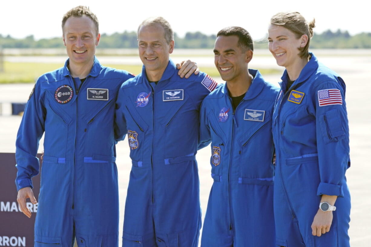 FILE - From left, European Space Agency astronaut Matthias Maurer of Germany, and NASA astronauts Tom Marshburn, Raja Chari, and Kayla Barron gather for a photo after arriving at the Kennedy Space Center in Cape Canaveral, Fla., on Tuesday, Oct. 26, 2021. A medical issue has sidelined one of four astronauts assigned to SpaceX's upcoming flight to the International Space Station and delayed the launch, officials said Monday, Nov. 1, 2021.