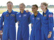 FILE - From left, European Space Agency astronaut Matthias Maurer of Germany, and NASA astronauts Tom Marshburn, Raja Chari, and Kayla Barron gather for a photo after arriving at the Kennedy Space Center in Cape Canaveral, Fla., on Tuesday, Oct. 26, 2021. A medical issue has sidelined one of four astronauts assigned to SpaceX's upcoming flight to the International Space Station and delayed the launch, officials said Monday, Nov. 1, 2021.