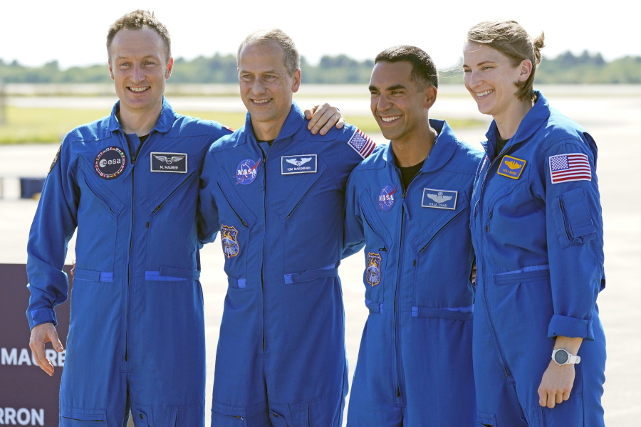 FILE - From left, European Space Agency astronaut Matthias Maurer of Germany, and NASA astronauts Tom Marshburn, Raja Chari, and Kayla Barron gather for a photo after arriving at the Kennedy Space Center in Cape Canaveral, Fla., on Tuesday, Oct. 26, 2021. A medical issue has sidelined one of four astronauts assigned to SpaceX's upcoming flight to the International Space Station and delayed the launch, officials said Monday, Nov. 1, 2021.