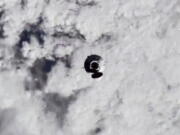 In this image from video made available by NASA, astronauts in the SpaceX Dragon capsule approach the International Space Station on Thursday, Nov. 11, 2021.