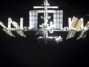 In this image from video provided by NASA, the International Space Station is seen as astronauts in the SpaceX Dragon capsule undock on Monday, Nov.