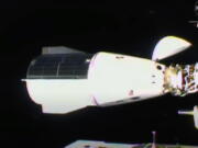 This image from video provided by NASA shows the SpaceX Dragon docking with the International Space Station, Thursday, Nov. 11, 2021. A SpaceX capsule carrying four astronauts pulled up Thursday at the International Space Station, their new home until spring. It took 21 hours for the flight from NASA's Kennedy Space Center to the glittering outpost.