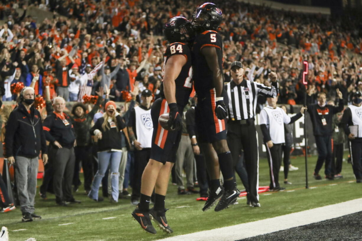 Oregon State tight end Teagan Quitoriano (84) and running back Deshaun Fenwick (5) celebrate Quitoriano's touchdown during the second half of an NCAA college football game Saturday, Nov. 13, 2021, in Corvallis, Ore. Oregon State won 35-14.