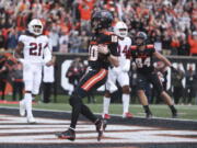 Oregon State quarterback Chance Nolan (10) runs into the end zone for a touchdown against Stanford during the first half of an NCAA college football game Saturday, Nov. 13, 2021, in Corvallis, Ore.