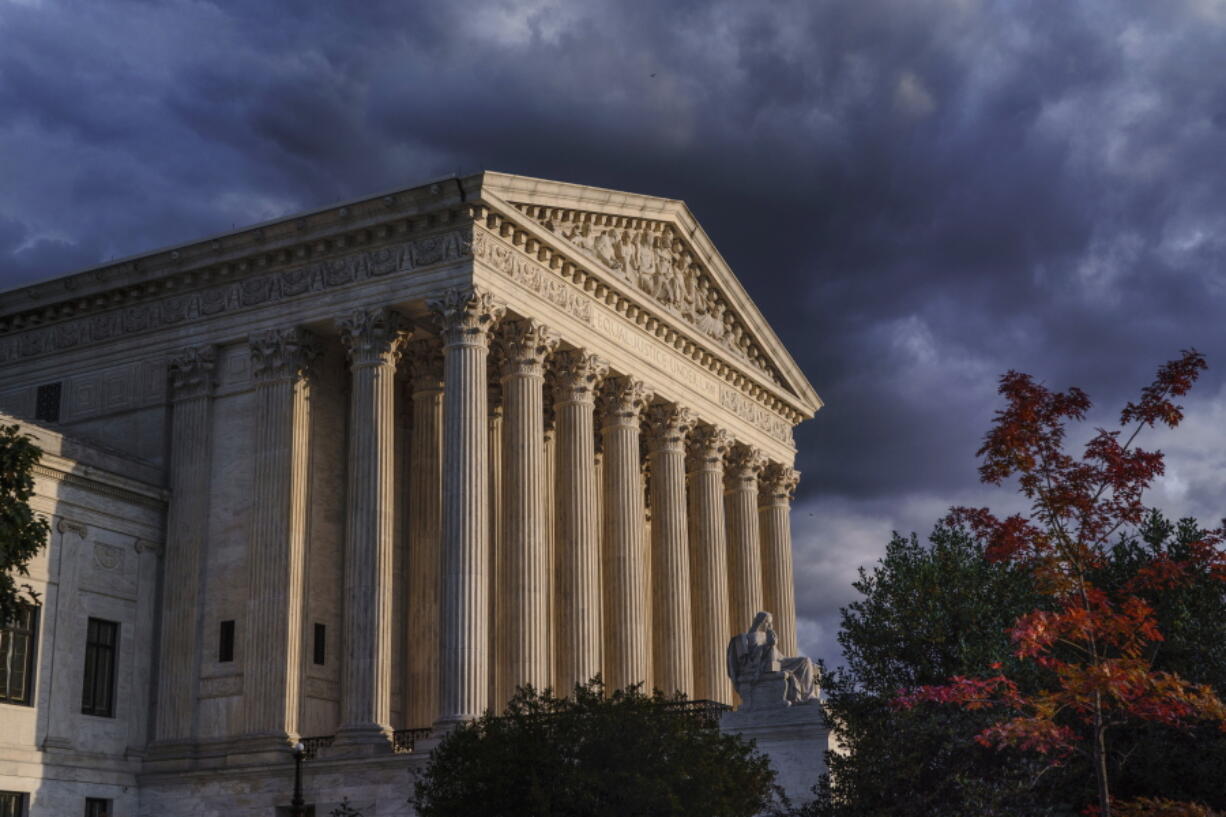 FILE - The Supreme Court is seen at dusk in Washington, Oct. 22, 2021. The Supreme Court is taking up challenges to a Texas law that has virtually ended abortion in the nation's second largest state after six weeks of pregnancy. The justices are hearing arguments Monday, Nov. 1, in two cases over whether abortion providers or the Justice Department can mount federal court challenges to the law, which has an unusual enforcement scheme its defenders argue shield it from federal court review. (AP Photo/J.