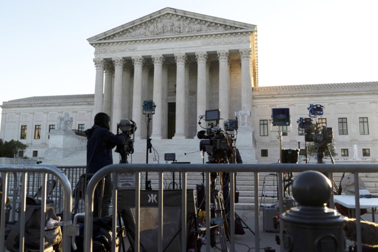 The U.S. Supreme Court is seen on Capitol Hill in Washington, Wednesday, Nov. 3, 2021, as television cameras are set up. The Supreme Court is set to hear arguments in a gun rights case that centers on New York's restrictive gun permit law and whether limits the state has placed on carrying a gun in public violate the Second Amendment.