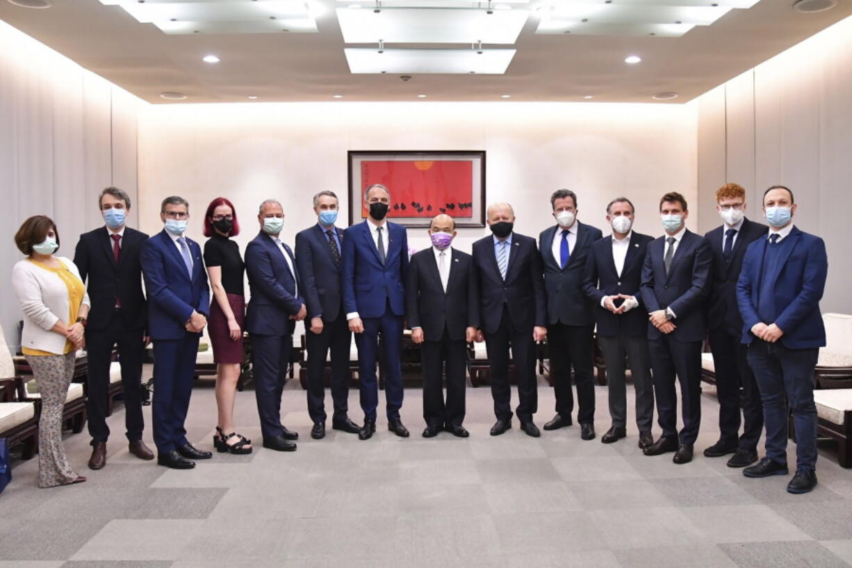 In this photo released by the Executive Yuan, Taiwan's premier Su Tseng-chang, center, poses for photos with European Union parliamentarians in Taipei, Taiwan, Wednesday, Nov. 3, 2021.