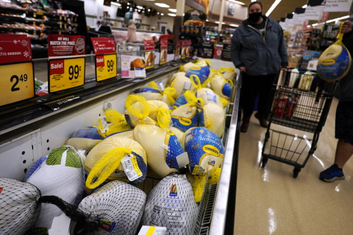 People shop for frozen turkeys for Thanksgiving dinner at a grocery store in Mount Prospect, Ill., Wednesday, Nov. 17, 2021.  First, the good news: There is no shortage of whole turkeys in the U.S. this Thanksgiving. But those turkeys -- along with other holiday staples like cranberry sauce and pie filling -- could cost more. (AP Photo/Nam Y.