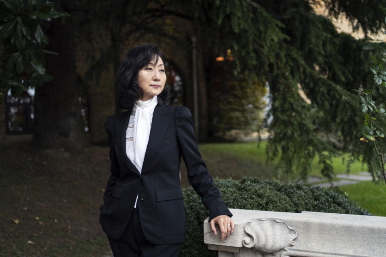 Grace Meng, the wife of former Interpol president Meng Hongwei, poses for a photo after an interview with the Associated Press in Lyon, central France, Tuesday, Nov. 16, 2021. In the exclusive interview, Meng chose to show her face for the first time since her husband disappeared in China in 2018, agreeing to be filmed and photographed without the dark lighting and from-the-back camera angles that she had previously insisted on. She did so to be able to speak openly and in unprecedented detail about her husband's imprisonment, herself and the cataclysm that tore them apart.