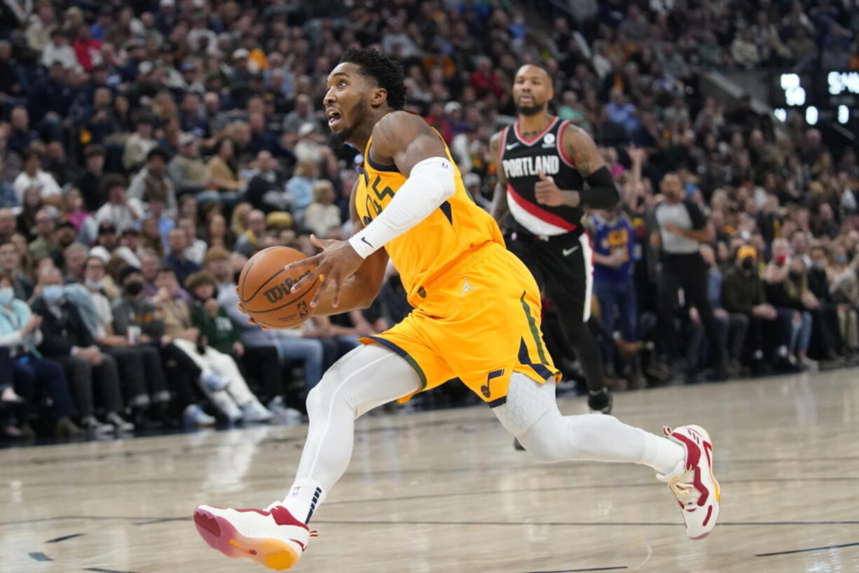 Utah Jazz guard Donovan Mitchell dunks against the Portland Trail Blazers in the second half during an NBA basketball game Monday, Nov. 29, 2021, in Salt Lake City.