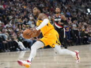 Utah Jazz guard Donovan Mitchell dunks against the Portland Trail Blazers in the second half during an NBA basketball game Monday, Nov. 29, 2021, in Salt Lake City.