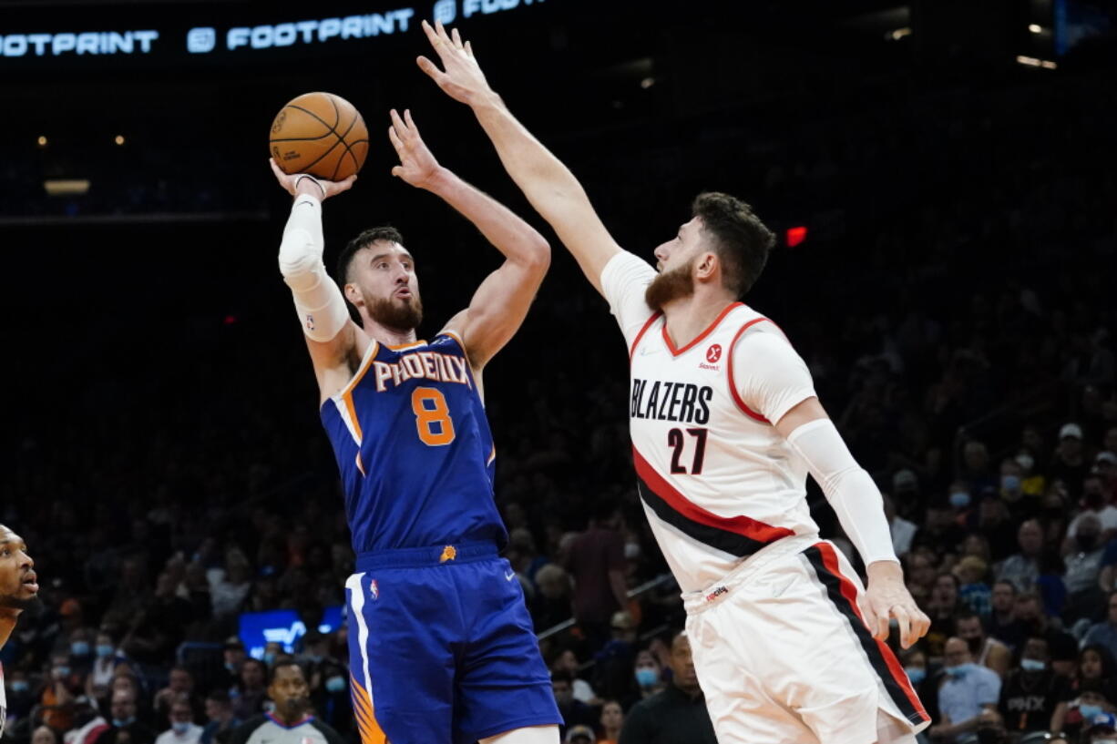 Phoenix Suns forward Frank Kaminsky (8) shoots over Portland Trail Blazers center Jusuf Nurkic (27) during the second half of an NBA basketball game, Wednesday, Nov. 10, 2021, in Phoenix.