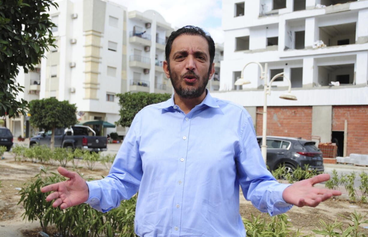 Yassine Ayari reacts during an interview in Tunis, Tuesday, Oct.12, 2021. Ayari, a 40-year-old Tunisian computer engineer turned corruption fighter, will stand trial again in a military court Monday Sept. 22. He is accused of insulting the presidency and defaming the army.