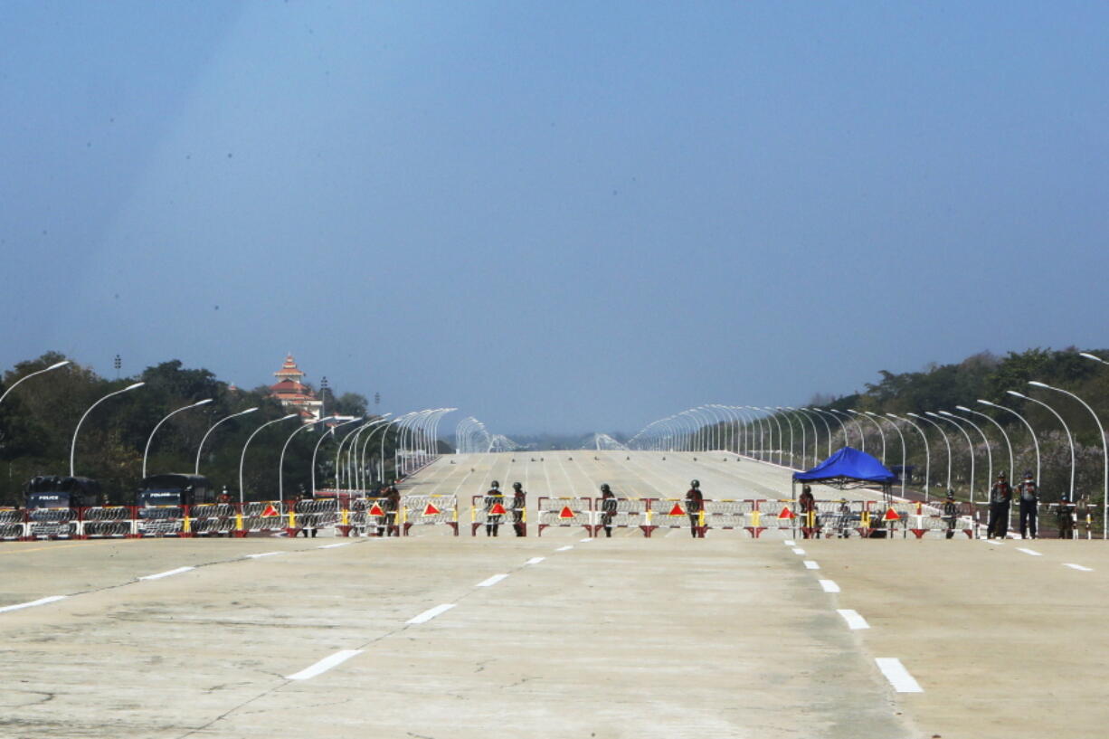 FILE - Soldiers stand to provide security near a road in Naypyitaw, Myanmar, Feb. 1, 2021. The head of the U.N. body investigating the most serious crimes in Myanmar said Friday, Nov. 5, that preliminary evidence collected since the military seized power on Feb.