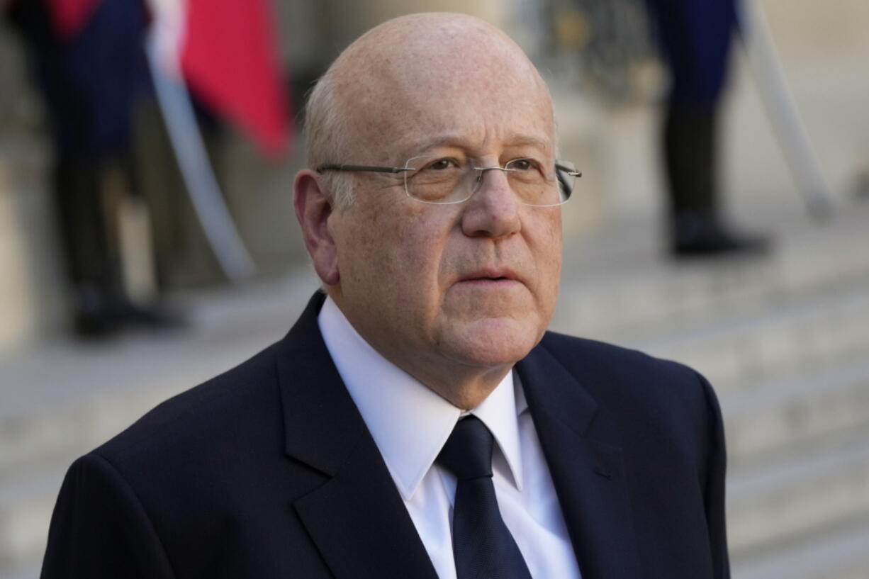 Lebanese Prime Minister Najib Mikati attends a joint press conference with French President Emmanuel Macron after their meeting at the Elysee Palace, in Paris, on Sept. 24, 2021. Pope Francis told Lebanon's prime minister on Wednesday that he was praying that God would help Lebanon "get up" and get back on its feet following an unprecedented economic crisis that has thrown three quarters of the country's 6 million people, including a million Syrian refugees, into poverty. Prime Minister Najib Mikati met privately with Francis for about 20 minutes and gave him a tile from a 19th century Beirut church that was seriously damaged in the August 2020 port explosion that killed 216 people and injured more than 6,000.