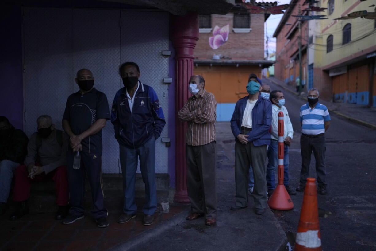 Venezuelans line up to vote during regional elections, at a polling station in Caracas, Venezuela, Sunday, Nov. 21, 2021. Venezuelans go to the polls to elect state governors and other local officials.