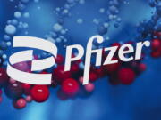 FILE - This Feb. 5, 2021, file photo shows the Pfizer logo displayed at the company's headquarters in New York.  Pfizer says its experimental pill for COVID-19 cut rates of hospitalization and death by nearly 90% among patients with mild-to-moderate infections. The company announced Friday, Nov. 5,  it will soon ask the U.S. Food and Drug Administration and international regulators to authorize its pill, which is taken twice a day for five days.